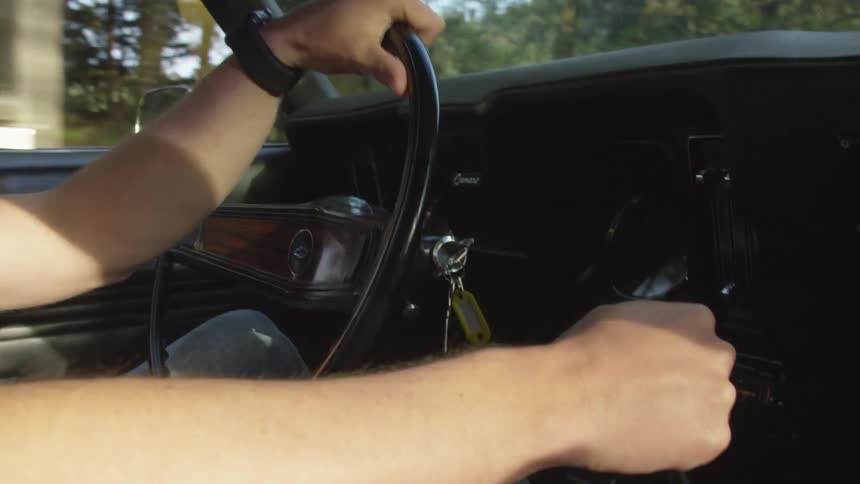 White man driving car on the road