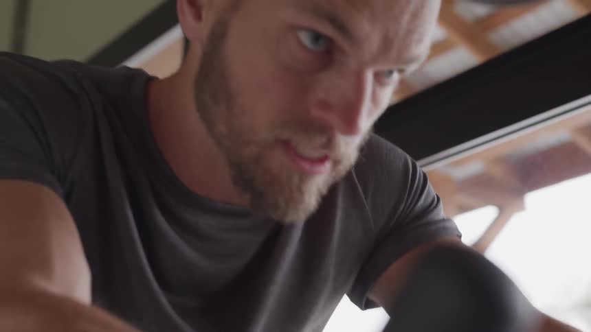 Bearded man trains on static bicycle