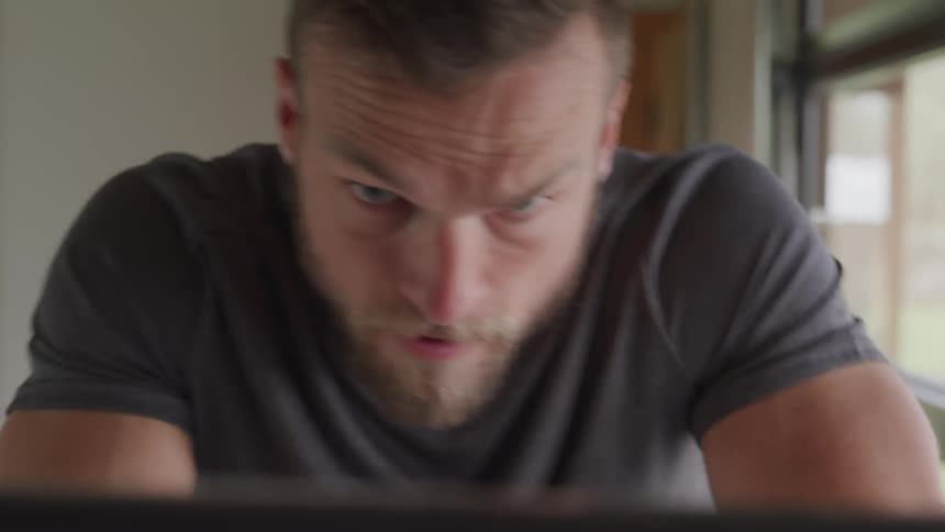 Blonde bearded man works out indoors during daylight