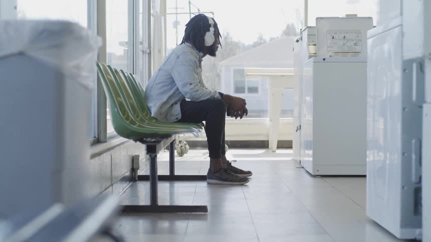 Man sitting on a bench in a building