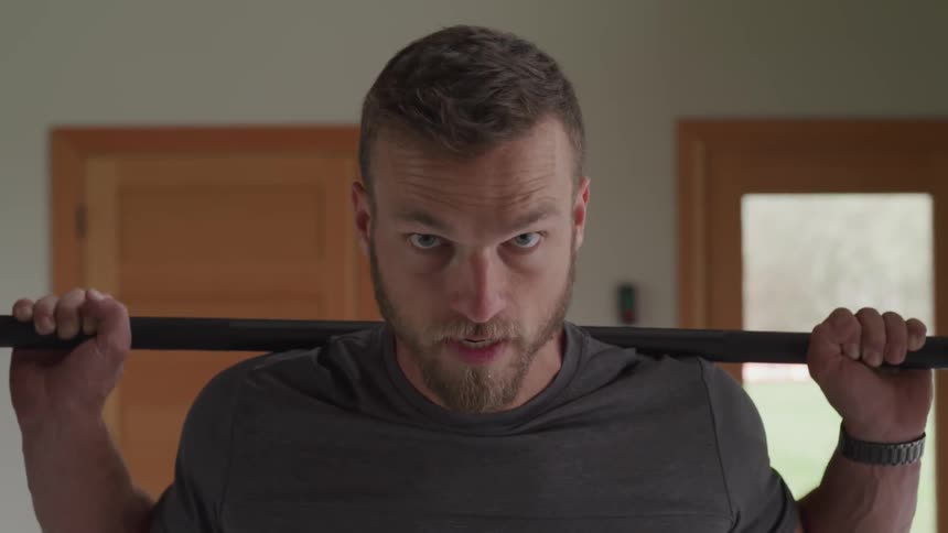 A man looks determined when working out at the gym