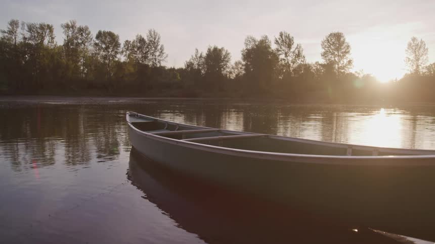 An empty boat sits in the lake water