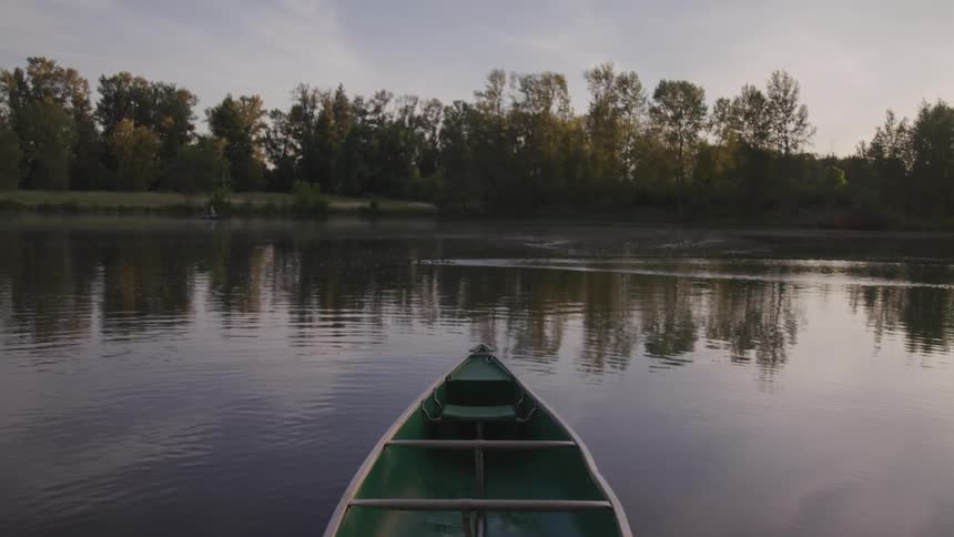 The front of a boat thats sitting on rippling water