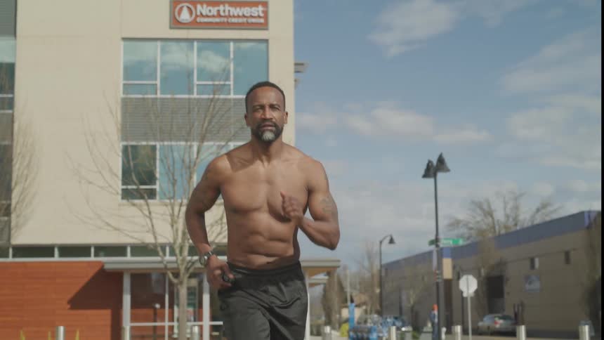 A man runs on the sidewalk