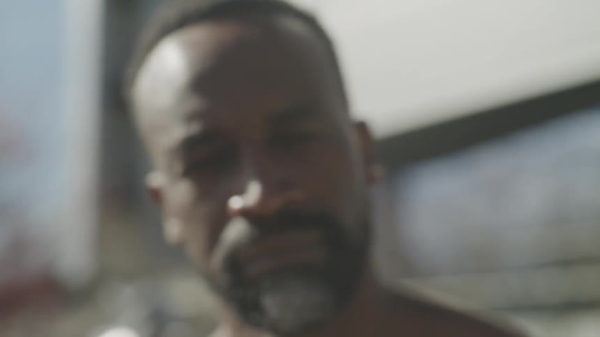 A man is looking around outside on a sunny day