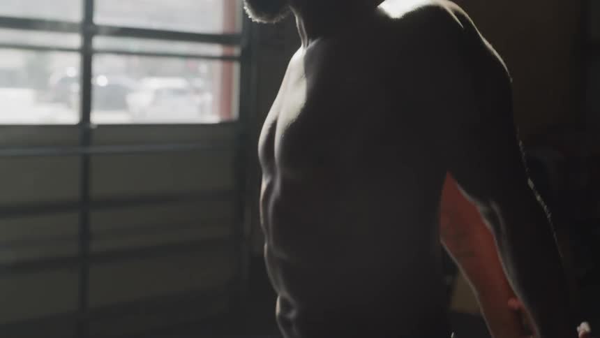 A man stretches his hands behind his back