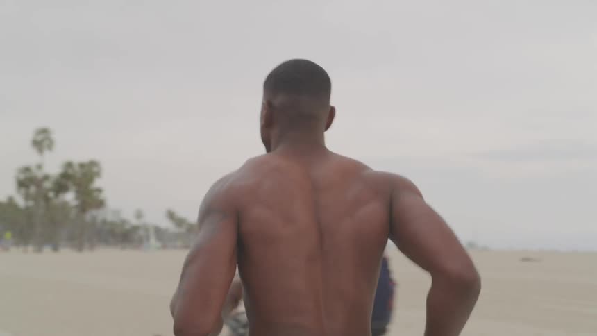 A man runs along a path on the beach