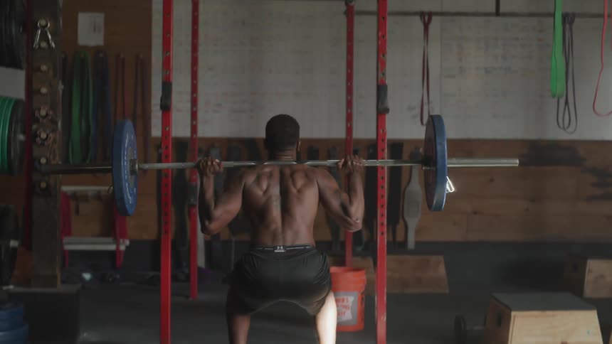 Man working out with weight lifting at the gym