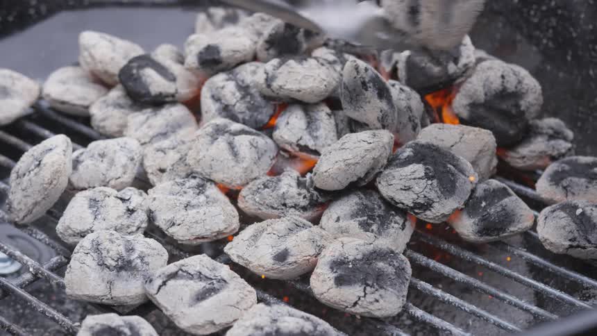 Person flipping hot coals