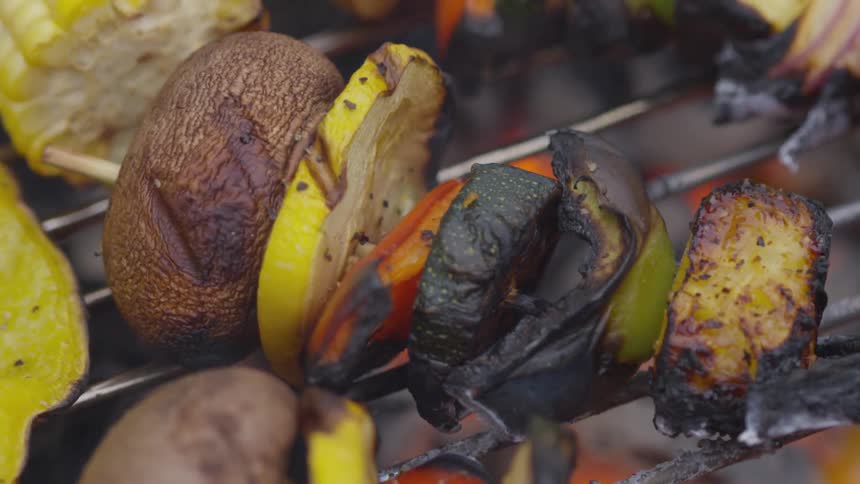 Shish kebabs and corn cooking on a barbecue grill