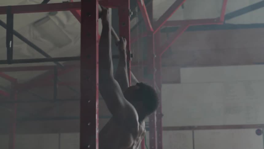 A man works out on the red frame