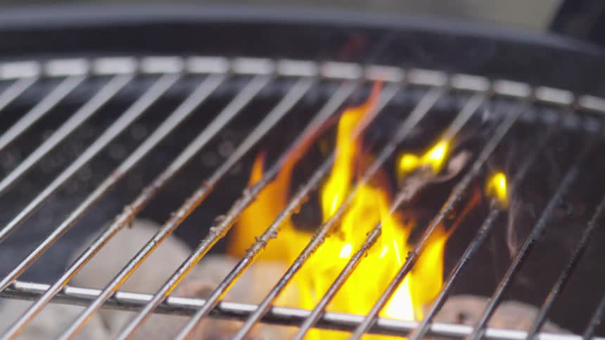 A fire burns in a grill