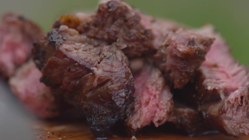 Sliced meat sitting on a cutting board