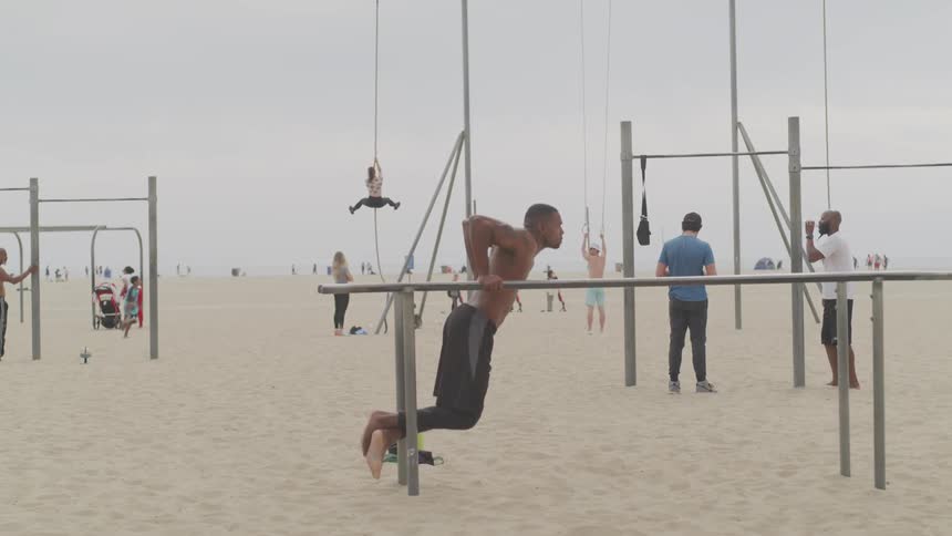 A man works out on the beach