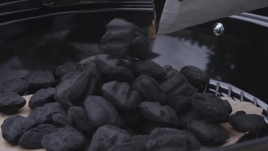 Coaling being poured into a grill