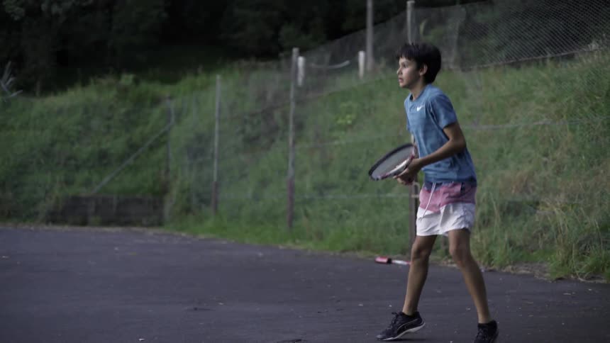 Young Kid Playing Tennis Outdoors on Court — Sunny Day Sports Footage Clip