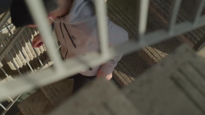 A man is jogging down a set of stairs