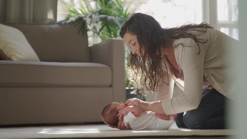 A mother tends to her newborn baby