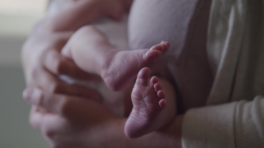 Mother holds baby in her arms