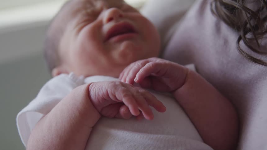 A woman is holding her baby