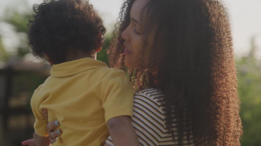 Mother holding and kissing herson