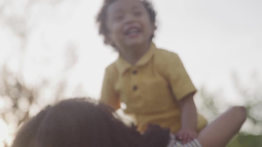 Mom holding boy on her back