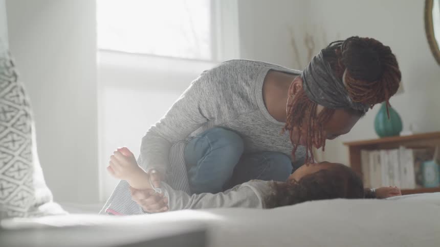 A woman kisses a child