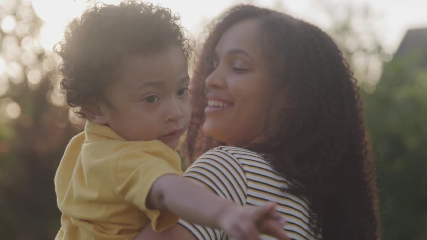 Mother and son are playing outdoors
