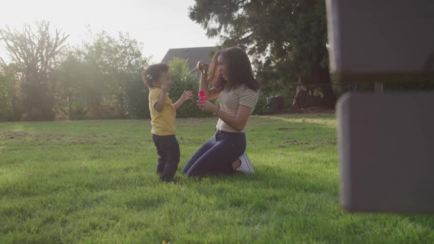 Mother and son are playing outdoors