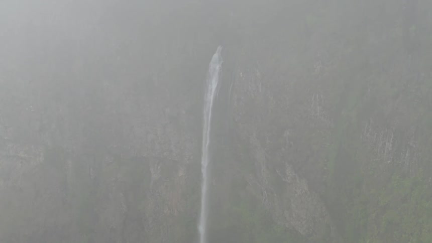 A waterfall flowing down the side of a canyon