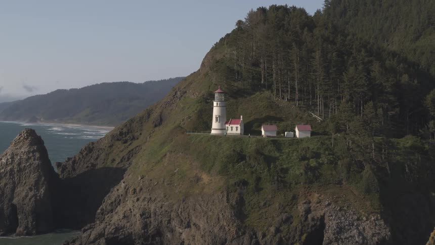 A lighthouse on a hill on the coast
