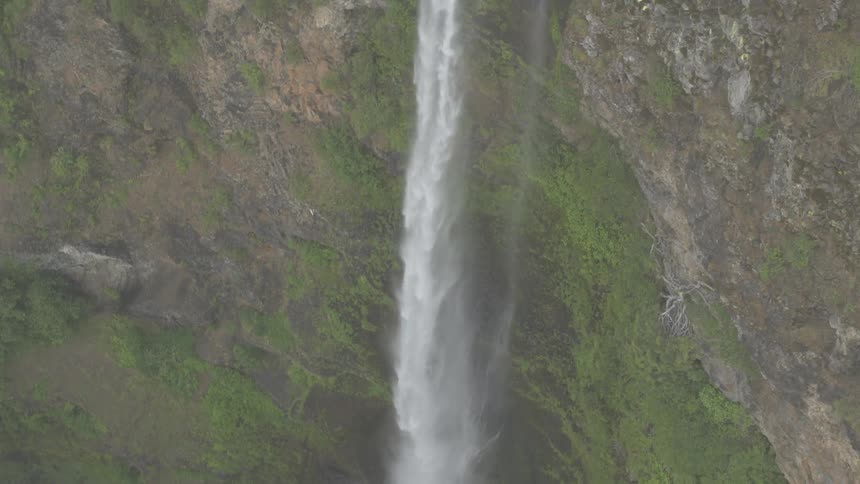 Water rushes over a steep cliff