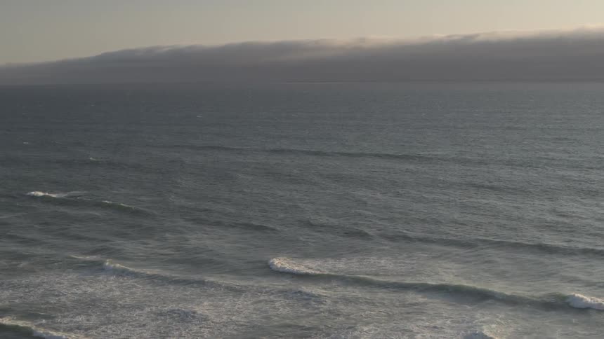 The ocean with waves and the sky and clouds in the background