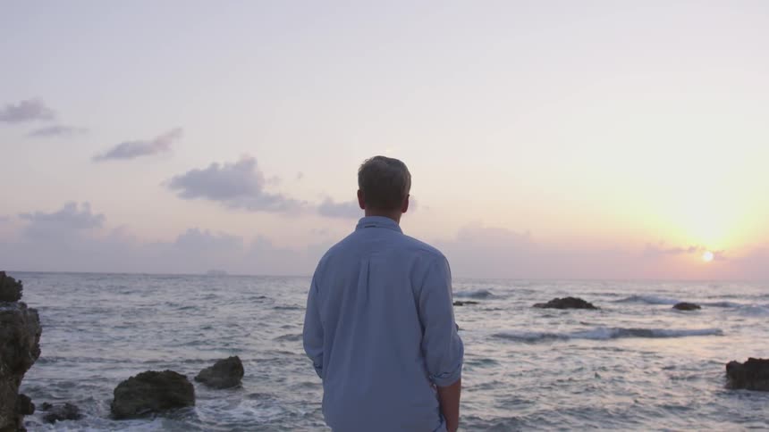 A man stares out to the ocean