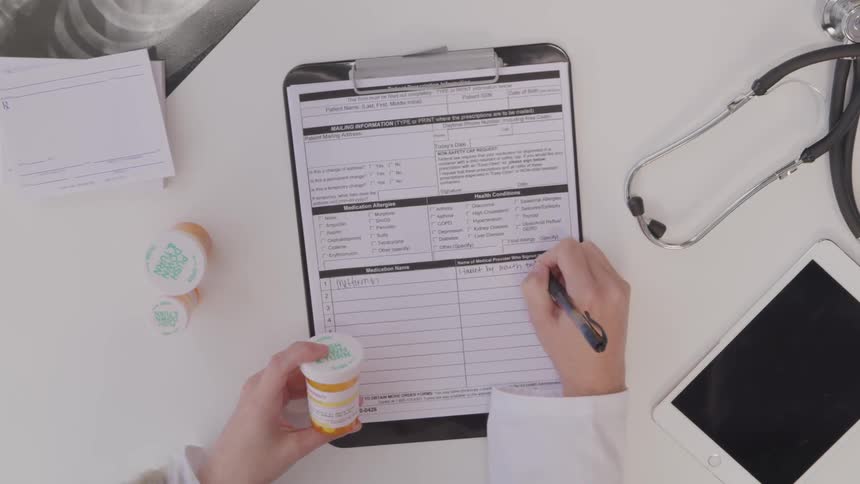 Doctor filling out medication order