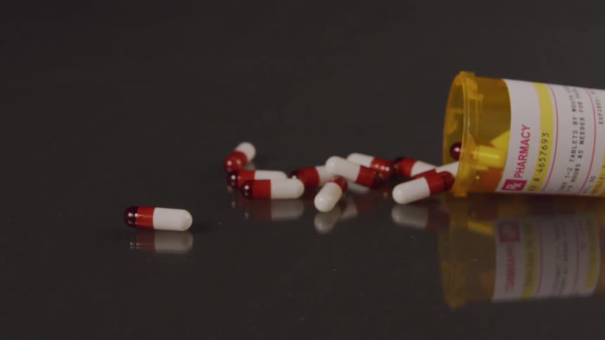 Pill bottle falling and spilling
