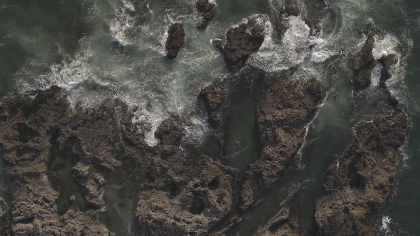 Waves crashing on volcanic rock