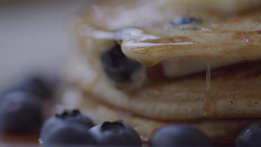 Syrup drips from the blueberry pancakes