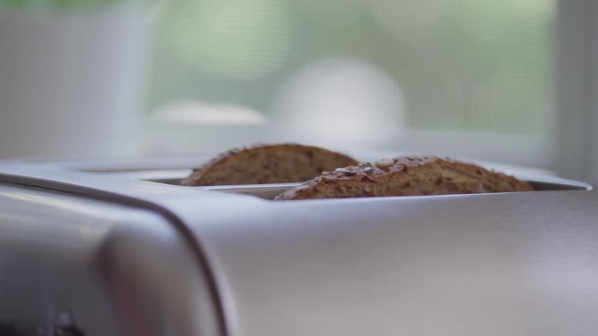 Toast pops up from the toaster upon completion of heating