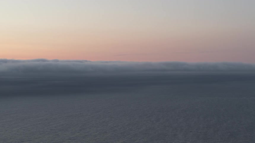 The ocean with the sky and clouds in the background