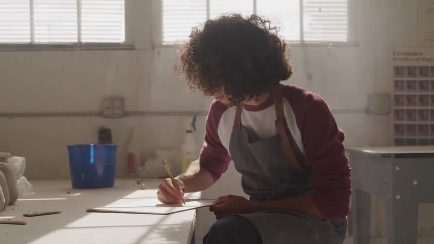 A man is drawing on a piece of paper