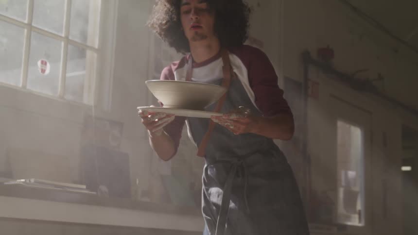 Male making a clay bowl