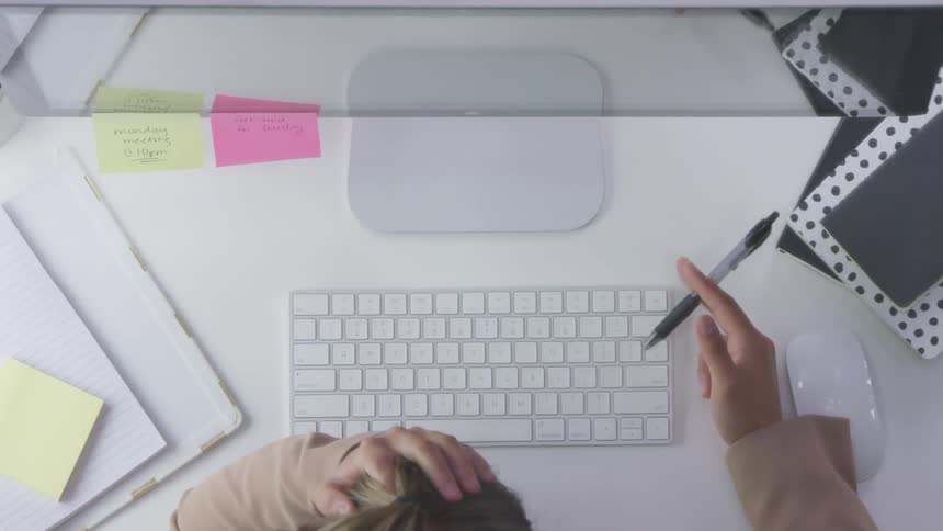 A worker thinking and playing with the pen on his hand