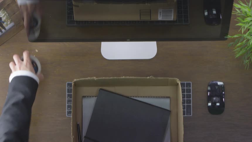 Man cleaning up his messy desk at the office