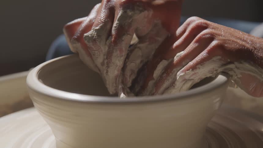 Human making a pottery bowl