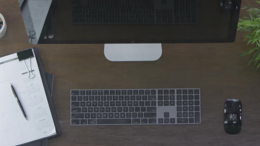 Hands type on a keyboard and grab a mug of coffee