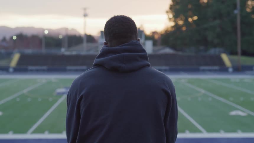 Man standing in front of a field