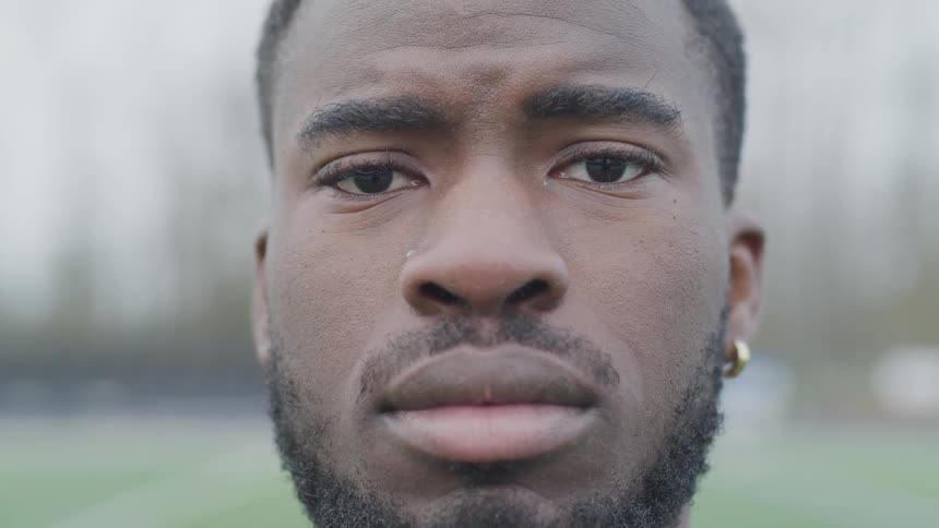 An african american man stares into the camera