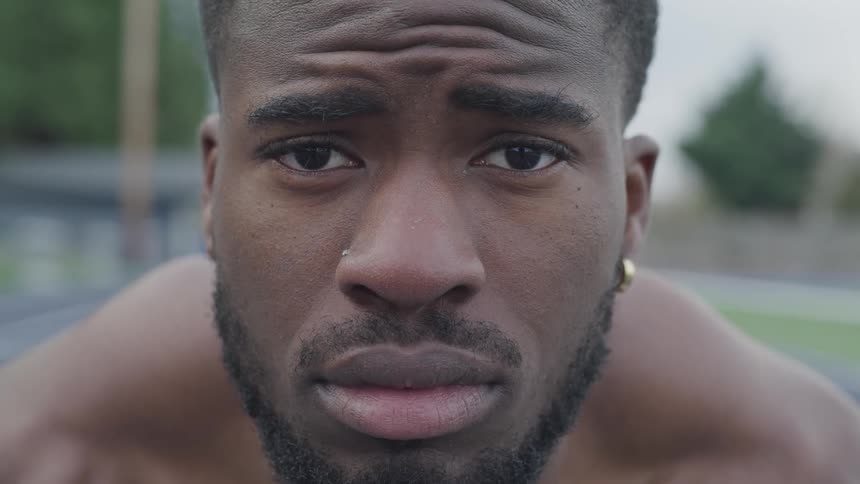 Black man stares ahead intently