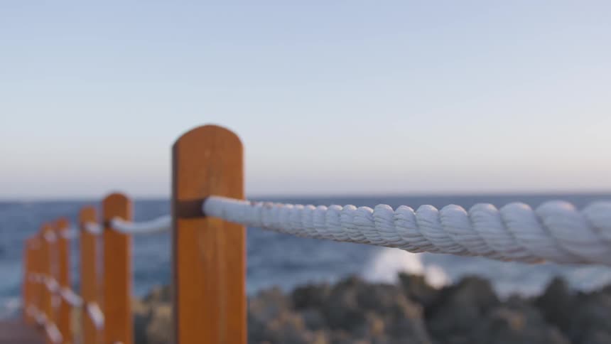 A pier and waves crashing in to rocks